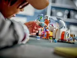 Child playing with LEGO vehicle.