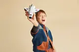 Child playing with LEGO shuttle.