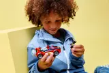 Child holds the car and Wolverine minifigure.