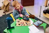 Child building LEGO set.