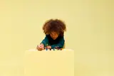 Child focused on LEGO figures.