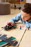 Child focused on LEGO play.