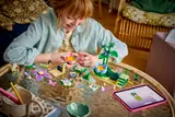 Child playing with LEGO Friends set.