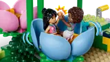 Minifigures in spinning flower cup.