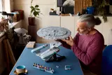 Man re-attaching saucer.