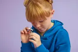 Child examining the LEGO telescope.