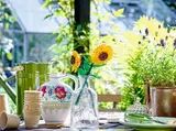 LEGO sunflowers in a vase in a greenhouse.