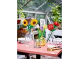 Variety of LEGO flowers on a pink table.