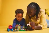 Adult and child playing with set.
