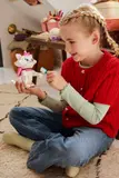 Child brushing Marie.