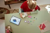 Child building Marie with digital instructions.