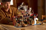 Builder admiring the Baratie model.