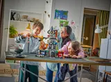 Children and adult playing with LEGO City 60473.