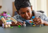 Child playing with minifigures from the set.