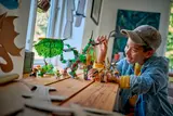 Boy playing with LEGO Ninjago Dragon of Life set.