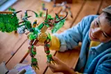 Boy posing LEGO Ninjago Dragon of Life's head.