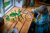 Overhead view of boy building LEGO Ninjago Dragon of Life with tablet.