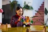 Person customizing LEGO Art Tiger