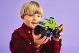 Child holding the Hulk monster truck.