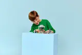 Child playing with LEGO Minecraft set.