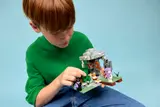 Child interacting with LEGO garden set.