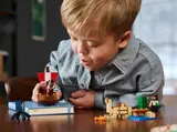 Child playing with LEGO Minecraft set.