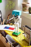 Skeleton on yellow pegboard.