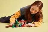 Child interacting with LEGO Minecraft build.