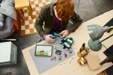 Overhead view of a person building LEGO Warden with digital instructions.