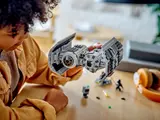 Child holding the LEGO TIE Bomber.