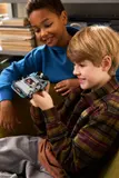 Kids holding finished LEGO DeLorean.