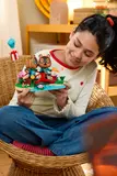 Holding LEGO Animal Crossing set.
