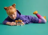 Child playing with open LEGO Friends accessory store.