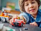 Child plays with LEGO car.