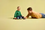 Child and adult playing with Toy Story set.