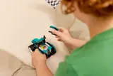 Child attaching part to tractor.