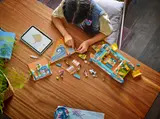 Child building catamaran with tablet instructions.