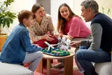 Family admiring LEGO world map.