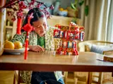 Girl playing with open LEGO Trotting Lantern.