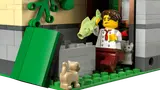 Chef minifigure with fish and cats outside restaurant.