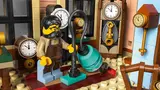 Clockmaker's workshop interior with minifigure and clocks.