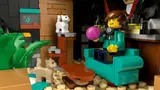 Attic apartment interior with minifigure, cats, and decor.