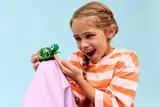 Girl holding LEGO turtle.