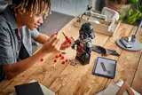 Building LEGO Darth Vader's lightsaber.