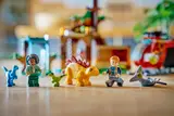 Minifigures and dinosaurs on floor.