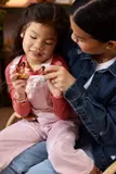 Child playing with Moana minifigures.