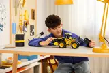 Child playing with loader model.