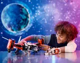 Child playing with VTOL spaceship and rover.