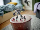 Mech with parts on a stool.