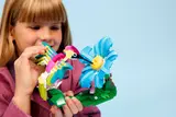 Child playing with LEGO hummingbird.